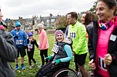 Man pushing woman in wheelchair