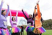 Enthusiastic runners in tutus cheering finish line