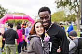 Portrait happy couple runners with medal