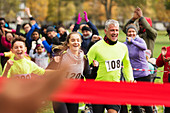 Enthusiastic family running, nearing finish line