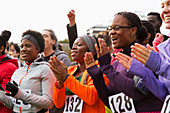 Marathon runners clapping, cheering