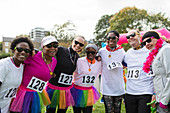 Portrait smiling runners in tutus