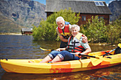Portrait smiling active senior couple kayaking