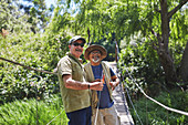 Portrait happy active senior men friends fishing
