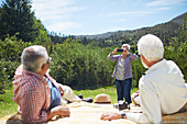 Active senior woman photographing men