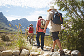 Active senior friends with backpacks hiking