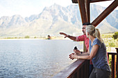 Couple with binoculars looking at lake view