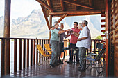 Active senior friends toasting wine glasses