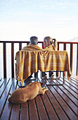Cosy couple and dog on balcony