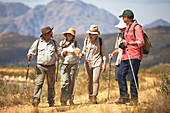 Active senior friends hiking with hiking poles