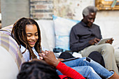 Smiling girl relaxing with family on sofa