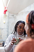 Women friends talking and drinking coffee