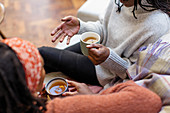 Women friends talking and drinking tea