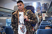 Young man with backpack boarding train