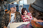 Young couple laughing on train