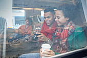 Young couple with coffee on train