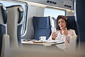 Businesswoman video chatting on train