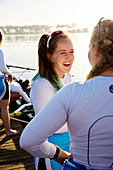 Female rowers smiling and talking