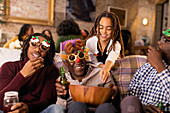 Playful family wearing Christmas glasses