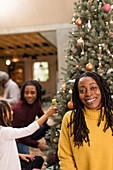 Mother decorating Christmas tree with children