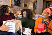 Enthusiastic family opening Christmas gifts