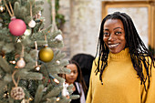 Portrait smiling woman at Christmas tree