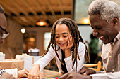 Grandfather and granddaughter playing board game