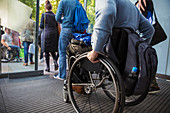 Man in wheelchair leaving office