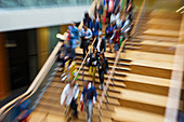 Blurred motion people descending wooden stairs