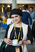 Businesswoman drinking coffee at conference