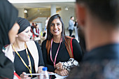 Smiling businesswomen talking at conference