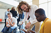 Business people using digital tablet at conference