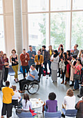 Audience clapping for male speaker in wheelchair