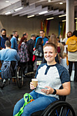 Woman in wheelchair drinking coffee at conference