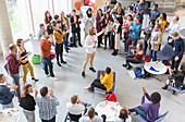 Audience clapping for businessman speaker at conference