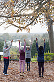 Active seniors practicing yoga, stretching