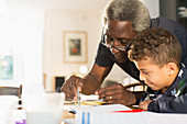 Grandfather helping grandson with geometry homework