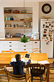 Boy doing homework at dining table