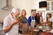 Active senior friends taking cooking class
