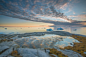 Idyllic clouds over ocean with icebergs, Greenland