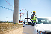 Engineer using walkie-talkie at truck