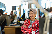 Smiling creative businesswoman working in office