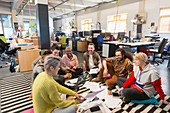 Business team meeting, brainstorming on floor in office