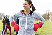 Portrait confident woman boxing in park