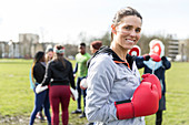 Portrait smiling woman boxing in park
