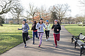 Smiling female runners running