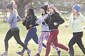 Smiling female runners running