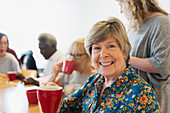 Senior woman drinking tea with friends