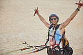 Portrait male paraglider strapped with equipment