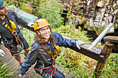 Portrait smiling woman preparing to zip line